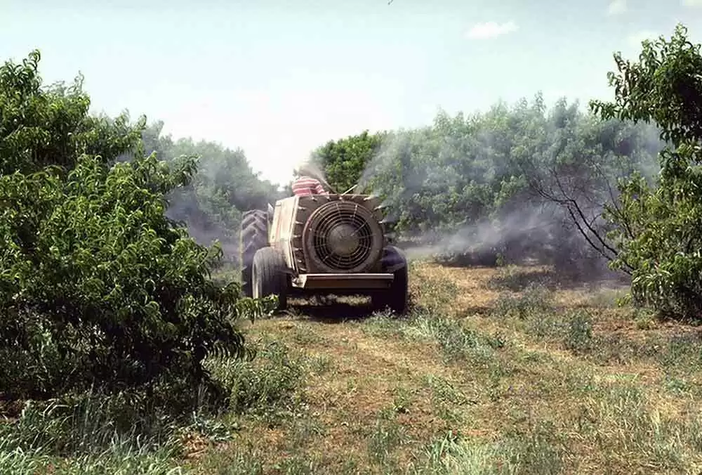 Persistent Chemical Exposure Means Higher Celiac Disease Rates - A farmer sprays pesticides. Image: CC pdm 1.0--USDAgov