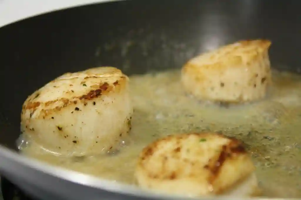 Scallops with Bacon and Wilted Spinach (Gluten-Free) - searing scallops by jordanmit09 is licensed under CC BY 2.0.