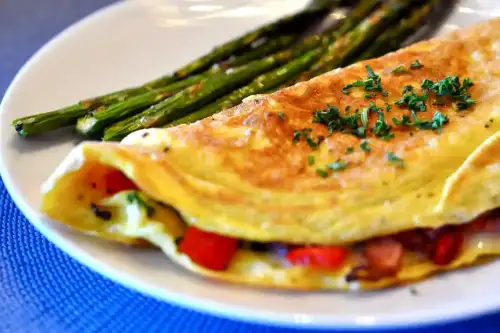 Do Omelets Contain Grain, and Are They Gluten-Free? - Omelet with Ham, Red Bell Peppers, and Cheese Filling by kimberlykv is licensed under CC BY 2.0.